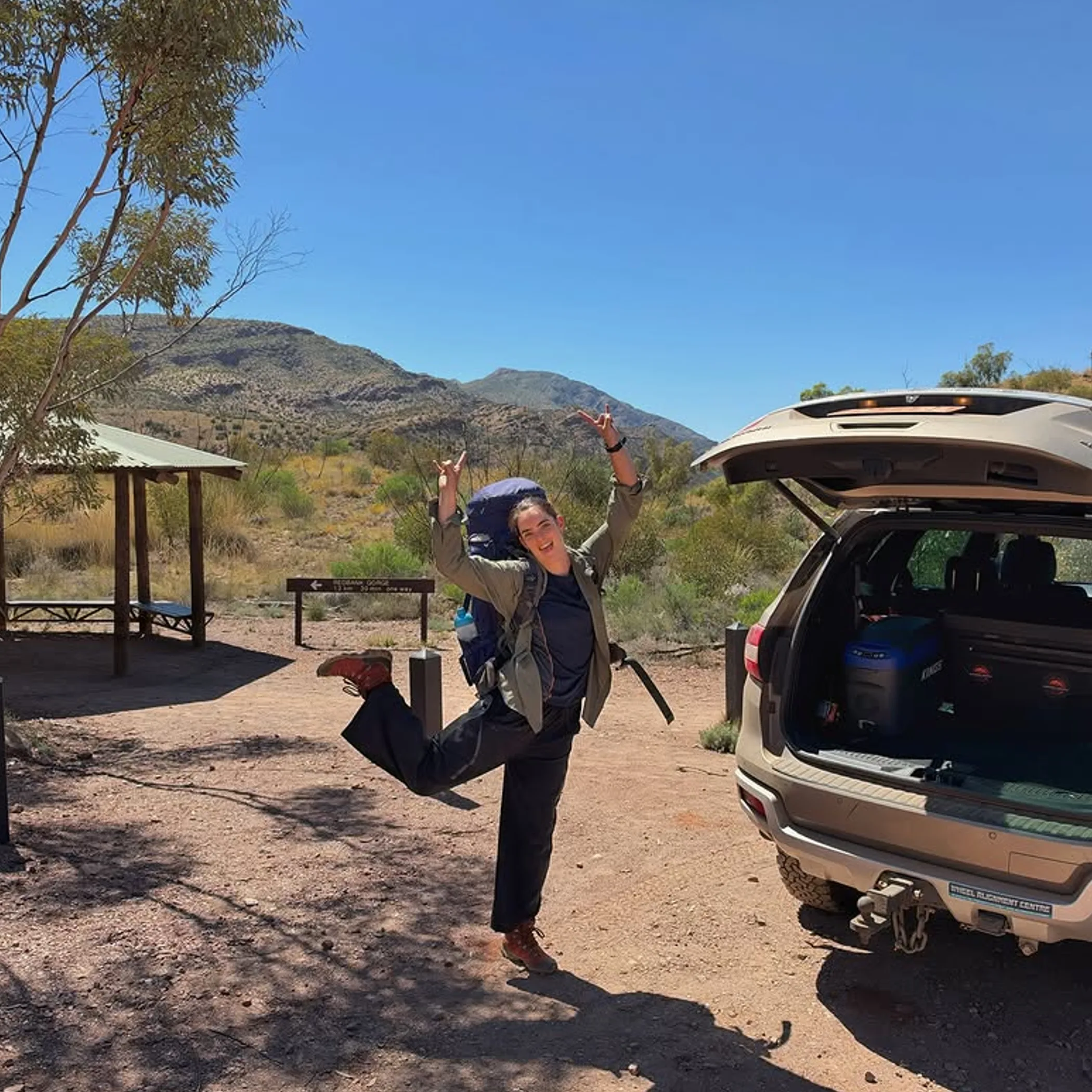 hiker and vehicle in larapinta landscape